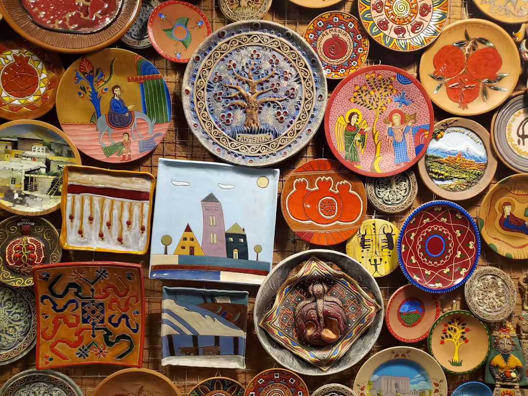 A wall of hand-painted traditional Armenian ceramic plates — the craft and warmth that welcome Estetime's international patients.
