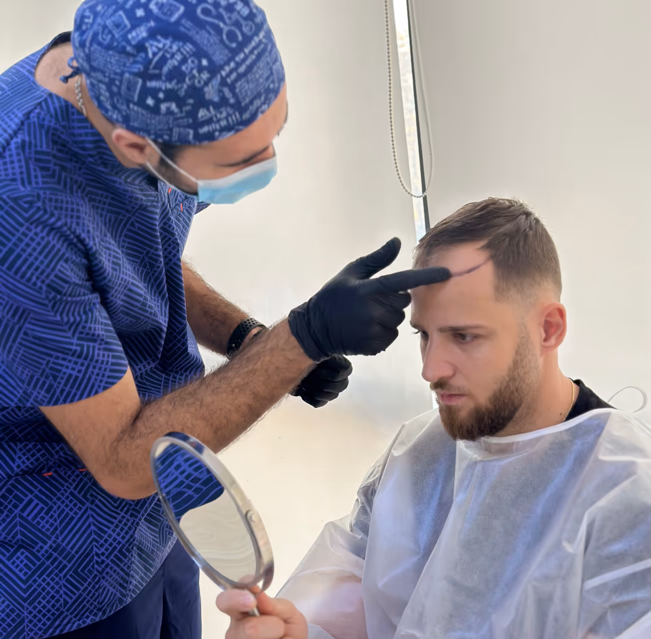 Estetime patient consulting with Dr. Vanand during hair assessment.